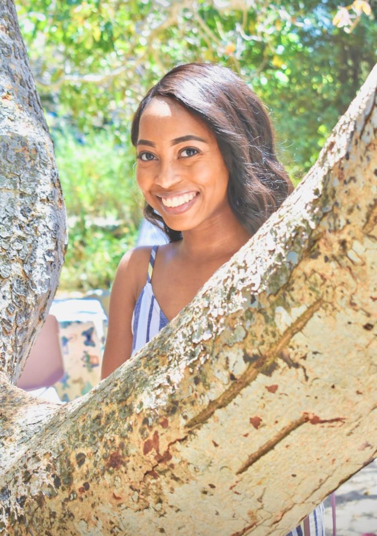 Woman Smiling Behind Tree image